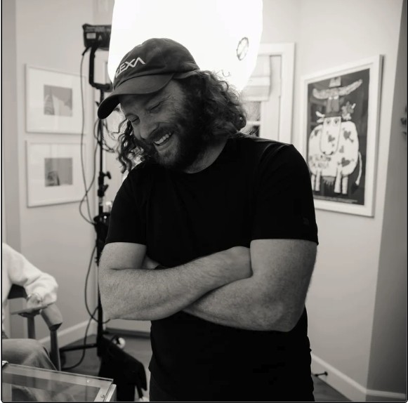 Sam Moskowitz on set, adjusting lighting during a production